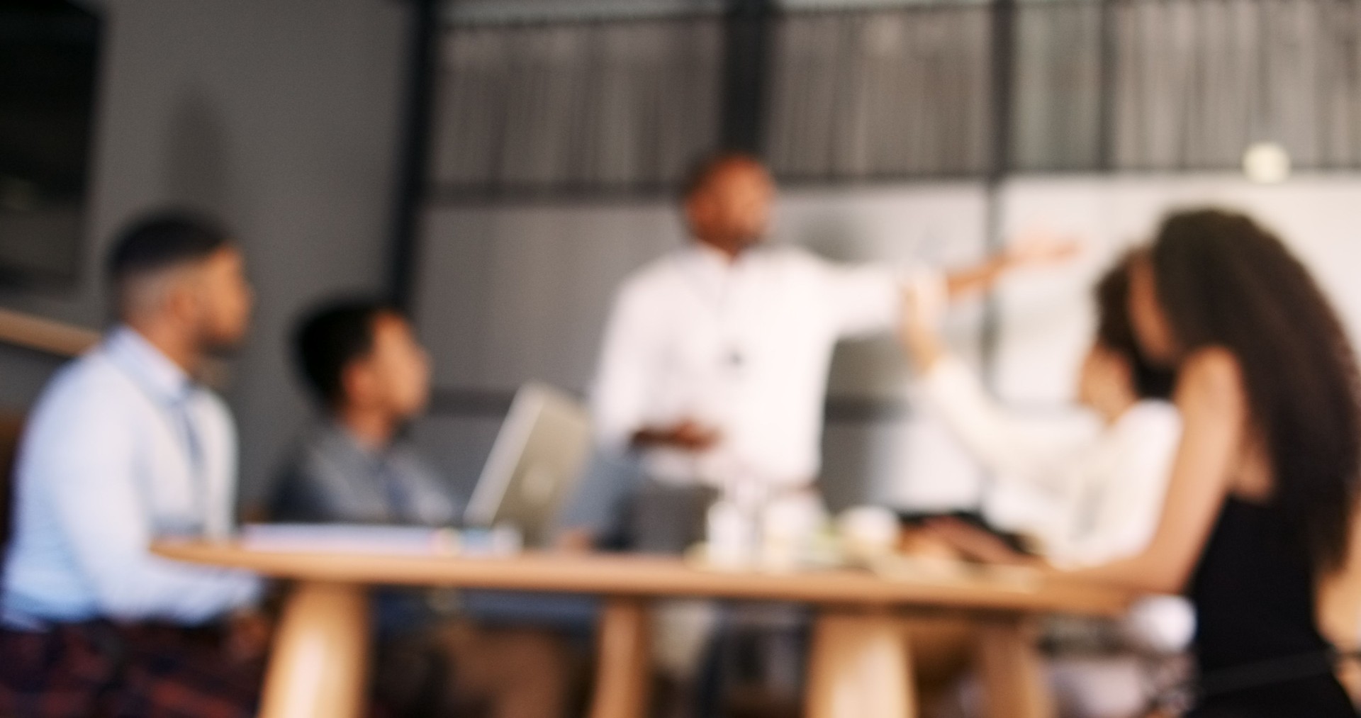 Blur, business people and meeting with team in boardroom, brainstorming for presentation with question and discussion. Corporate training, defocused workshop or collaboration for project strategy